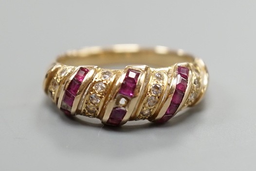 A modern 585 yellow metal, ruby and diamond chip set half hoop ring, size M/N, gross weight 3.3 grams.